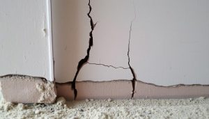 Cracked foundation wall in a Baytown home showing typical foundation damage